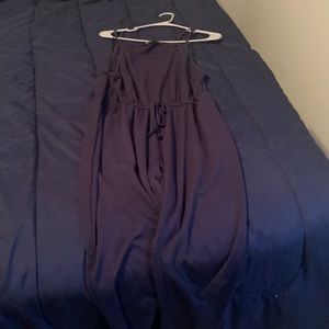 a pants jumpsuit navy blue spaghetti straps that fits tight at the bottom